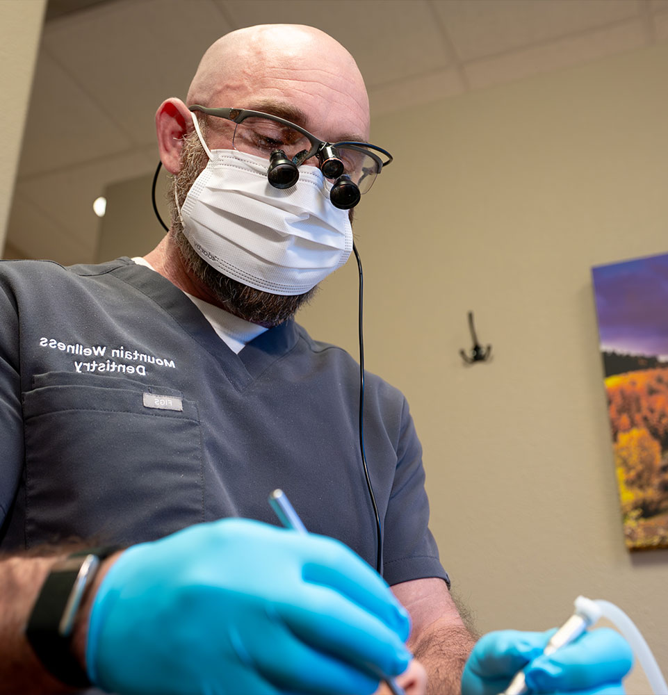 doctor performing dental treatment on patient