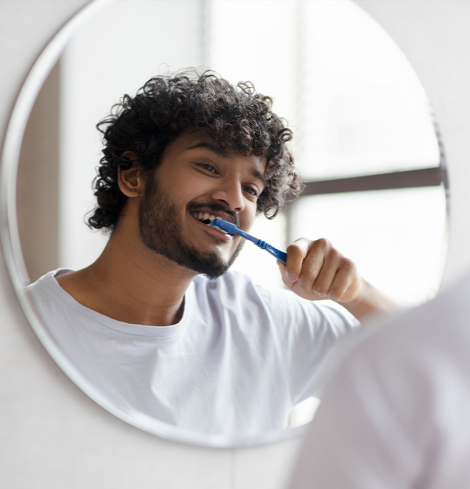 person brushing their teeth in their bathroom