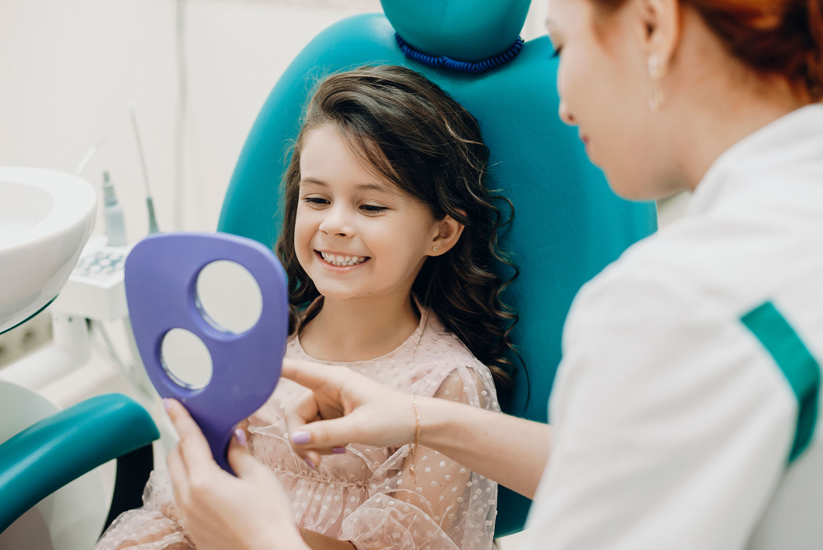 young child patient smiling brightly within the dental center