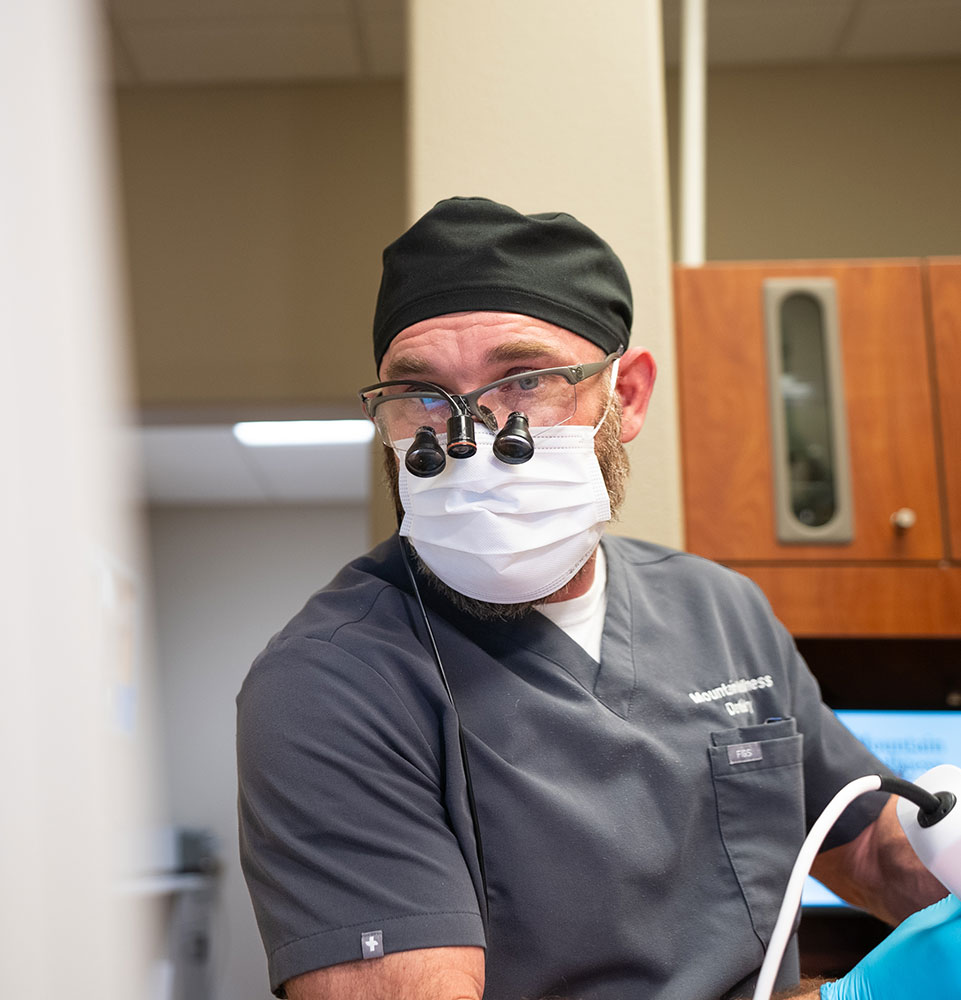 doctor examining dental patient for their treatment