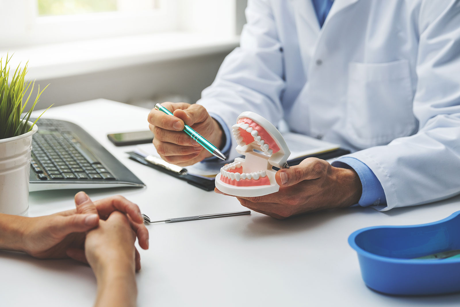 dentist and patient discussion about planned teeth treatment in dental clinic office