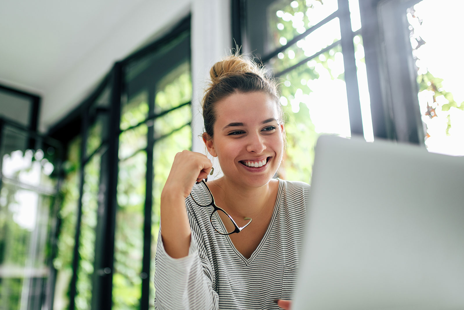 Beautiful smiling girl using laptop. Close-up.