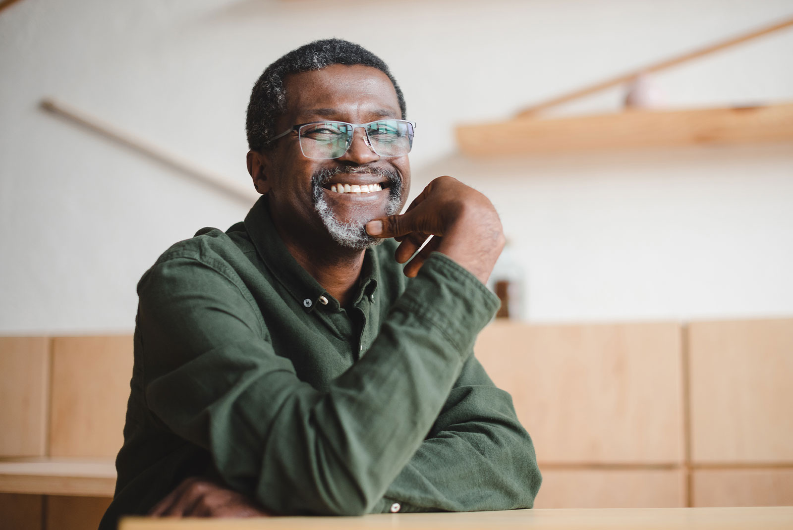 happy mature man smiling in cafe