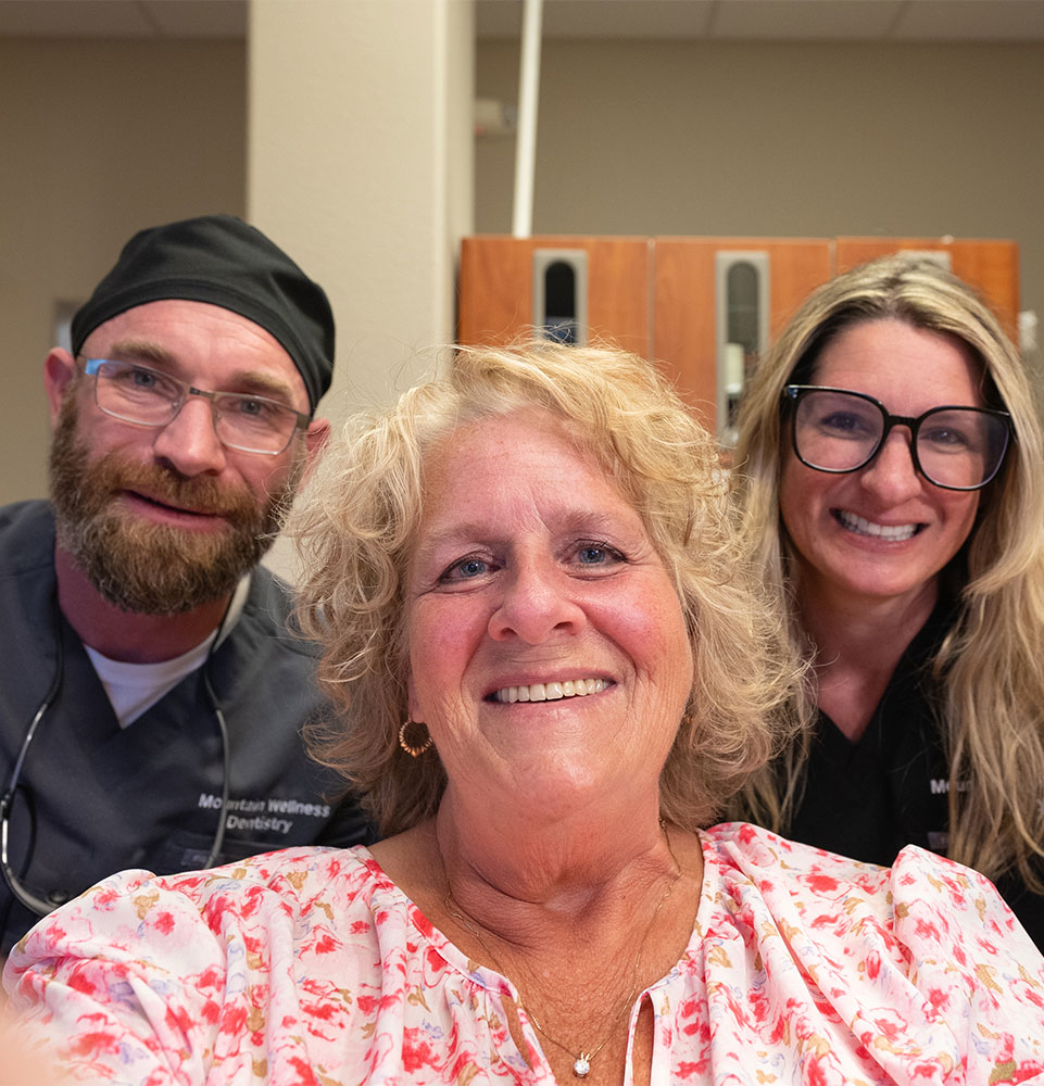patient and and staff members smiling with patient