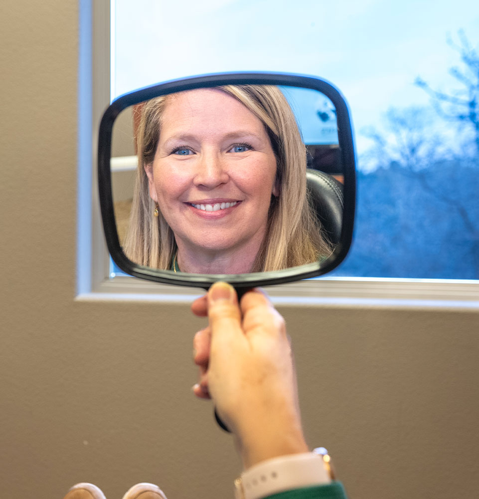 close up of dental implant patient ceiling within the mirror