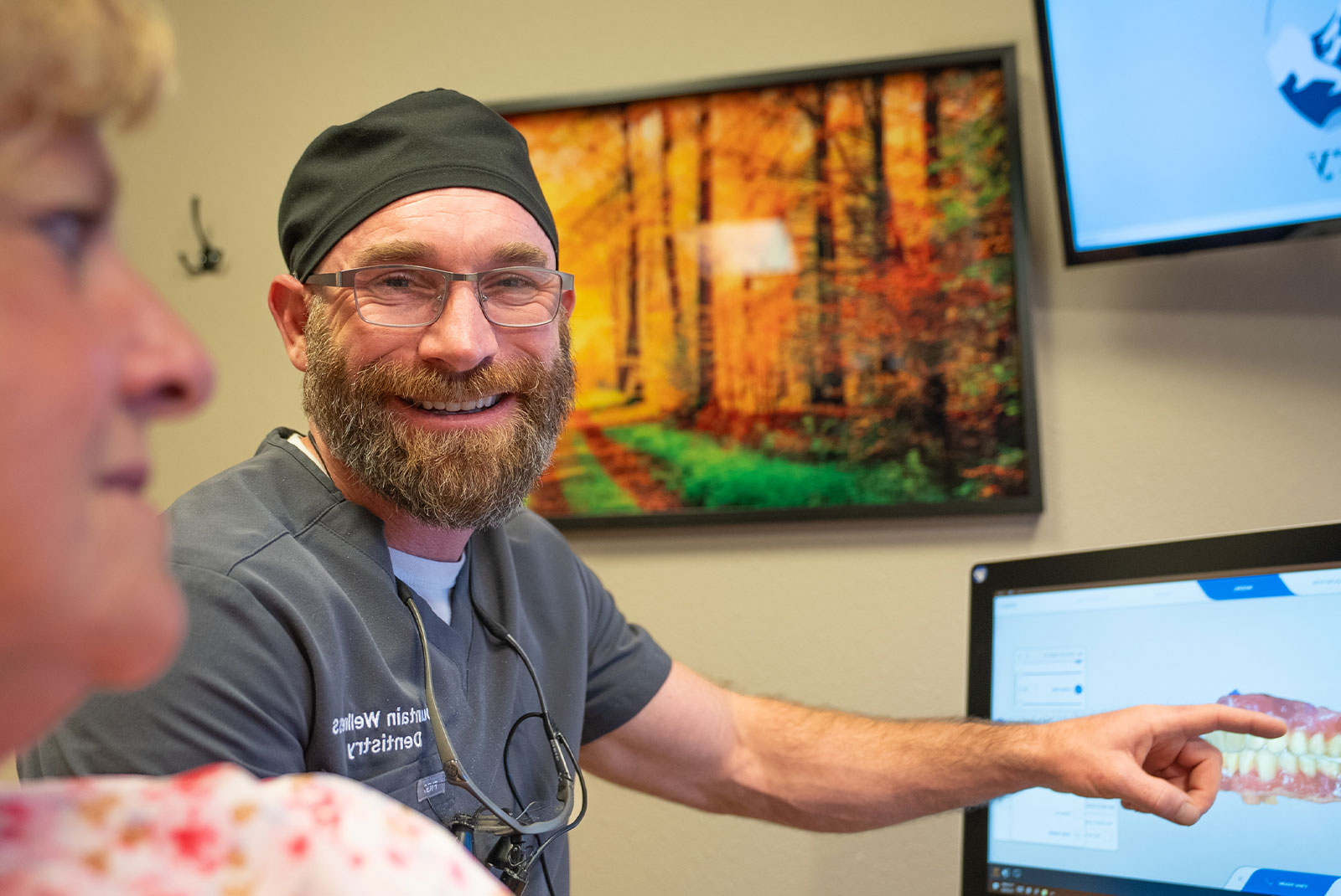 doctor going over dental procedure information within the dental center