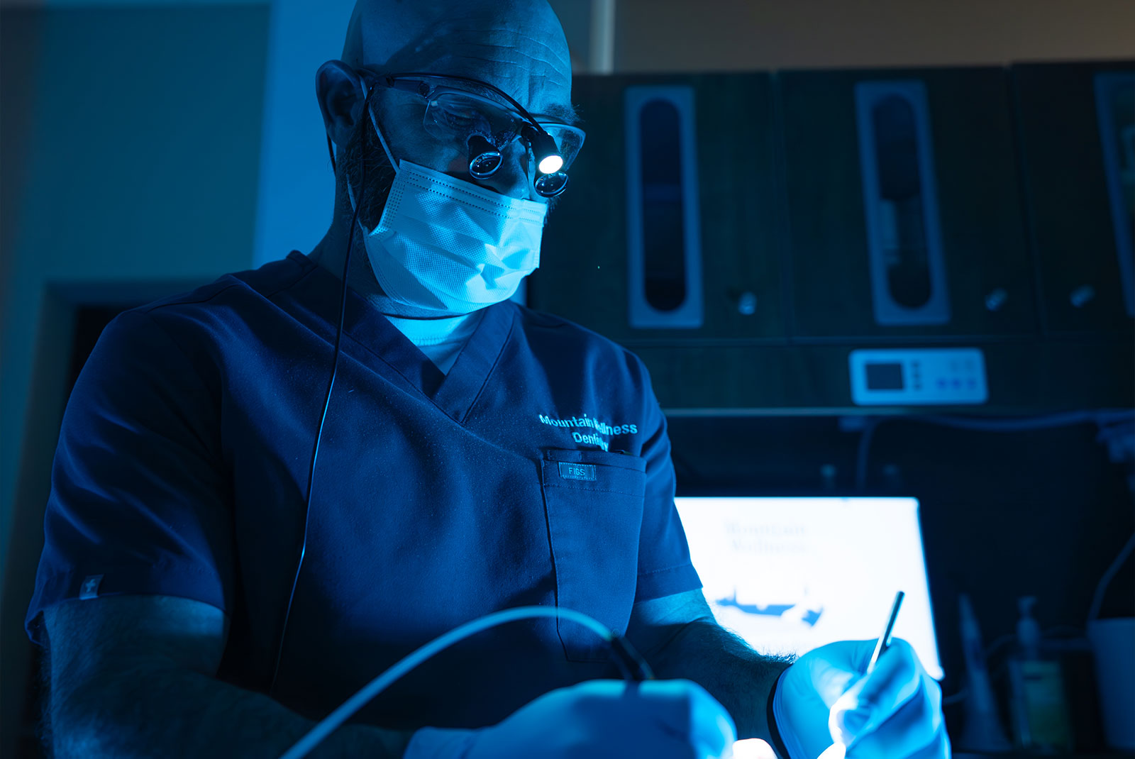 doctor performing laser dental procedures on patient