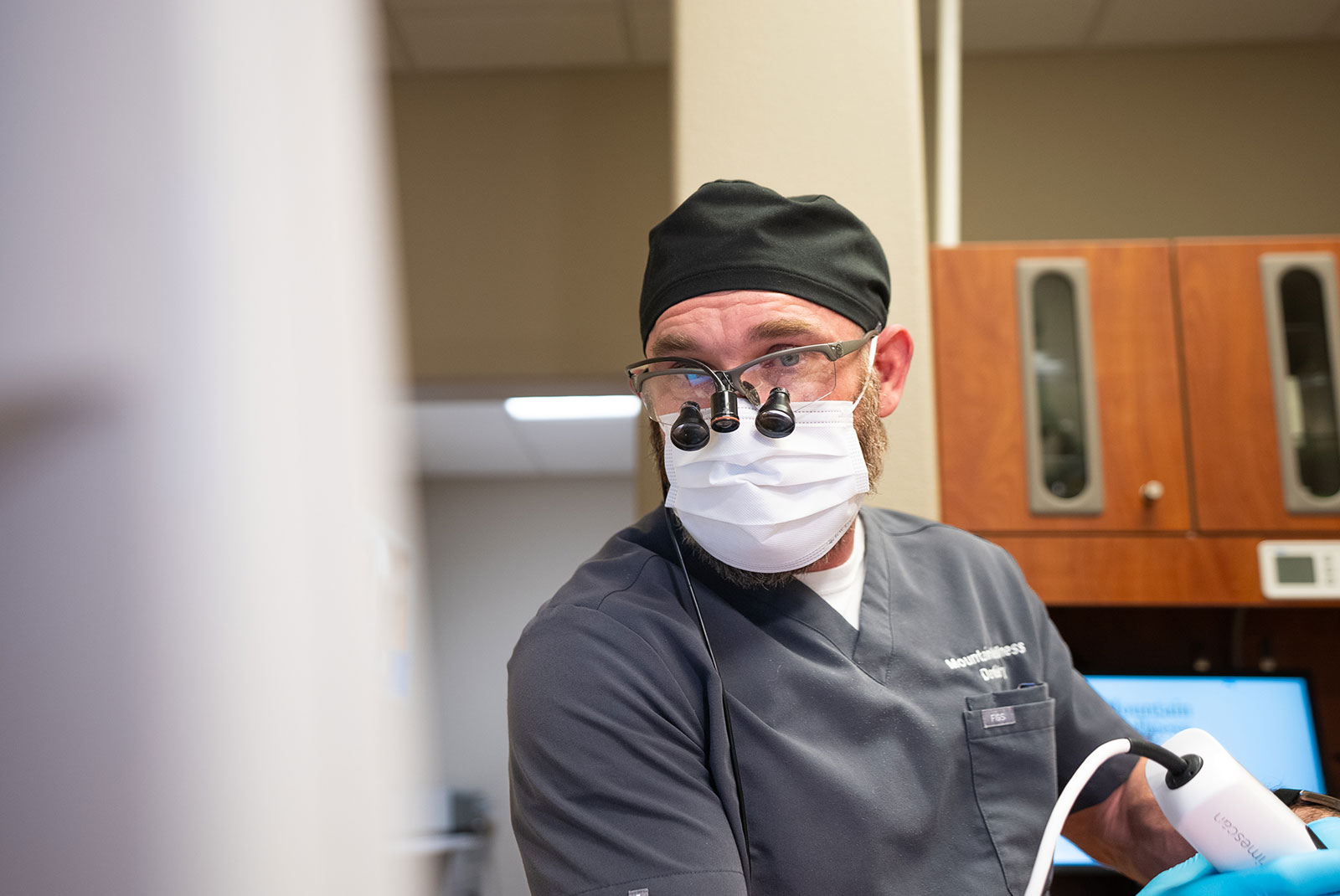 doctor examining dental patient for their treatment