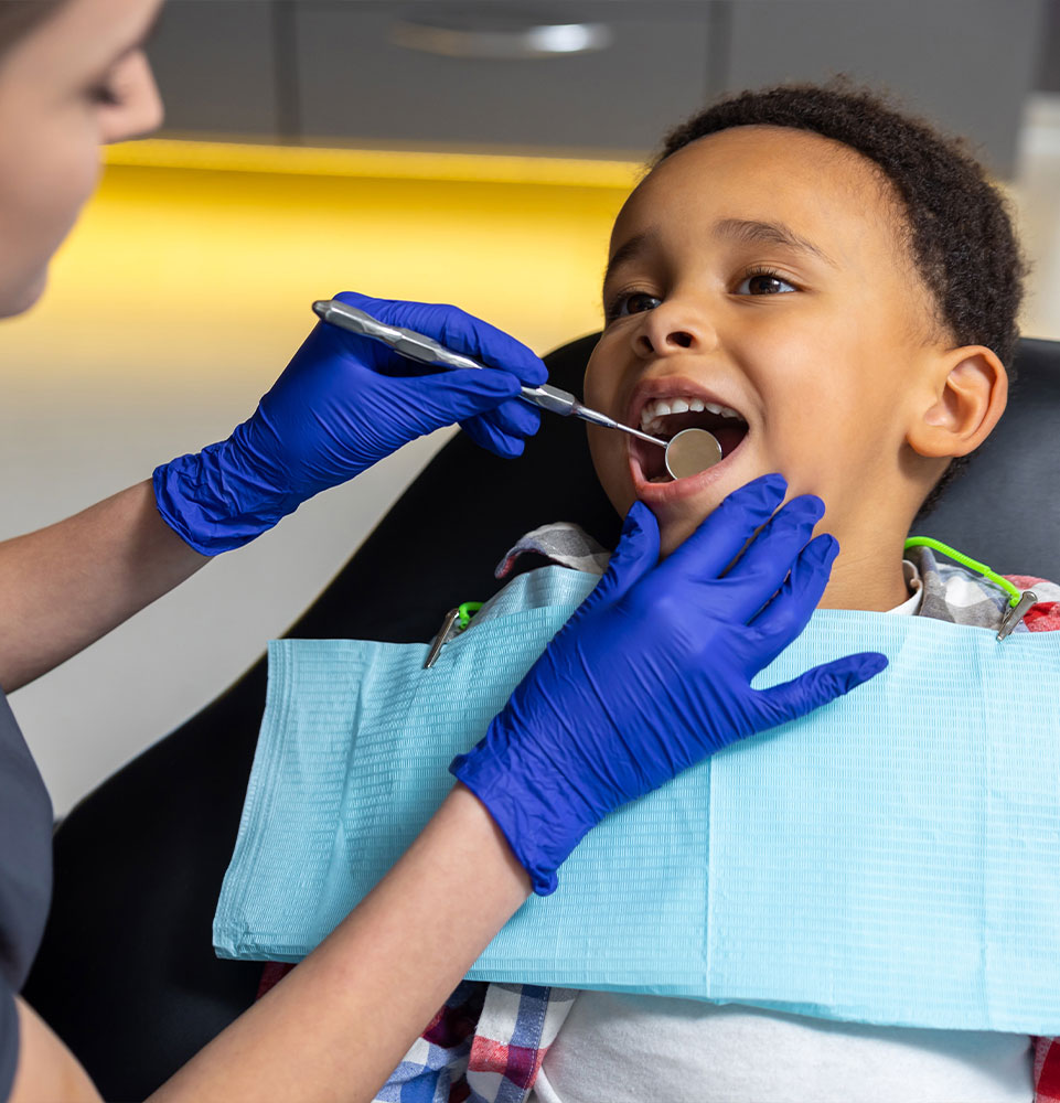 child being examined by hygienist