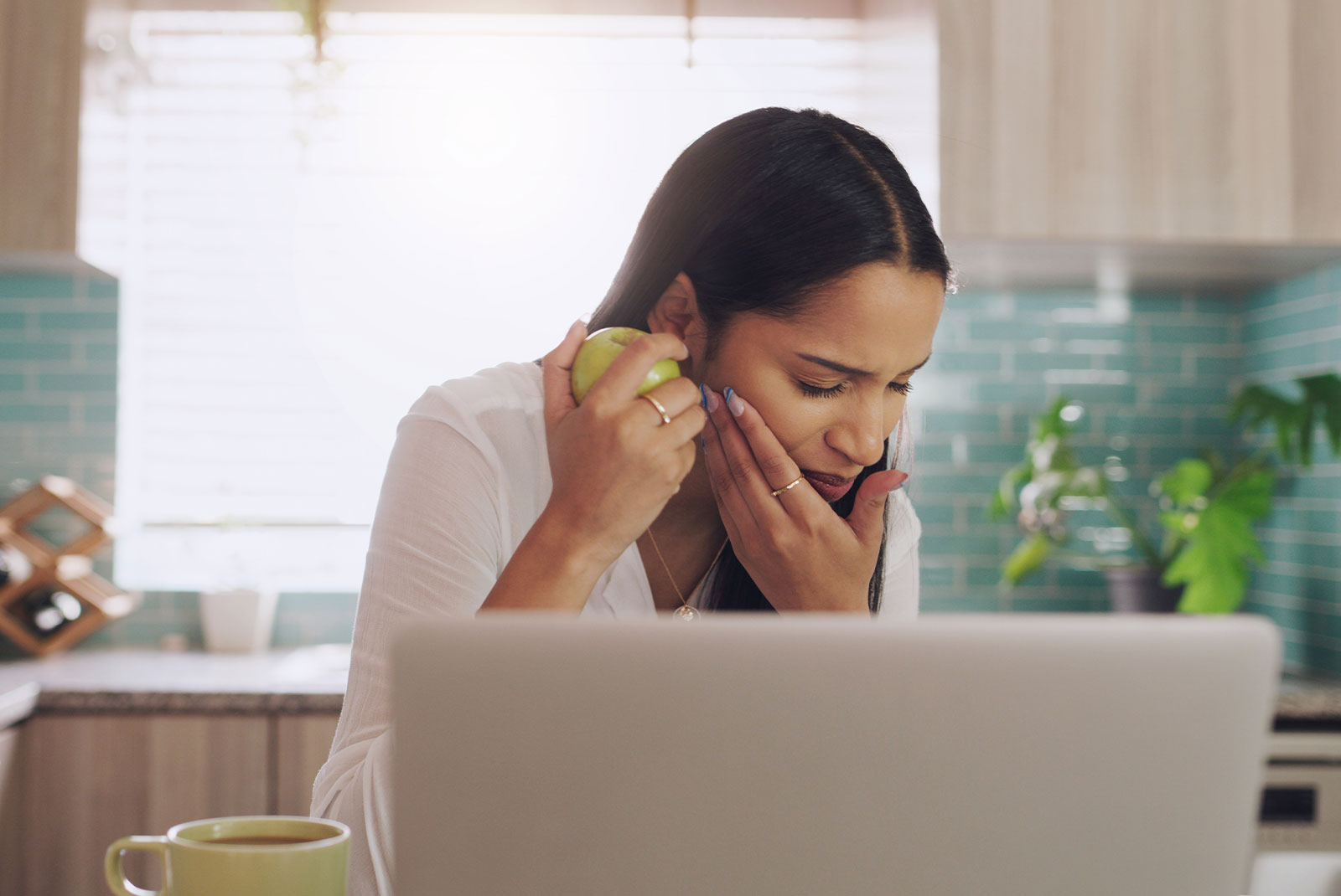 bite injury and woman with apple and food at home working on a computer