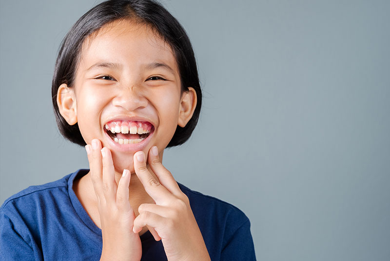 girl laughing with gummy smile